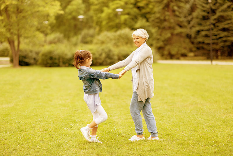 Older Woman Playing With Her Granddaughter - Yellowish Image
