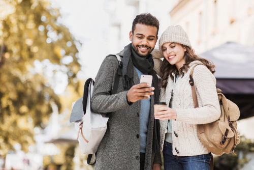 Couple looking at phone and smiling